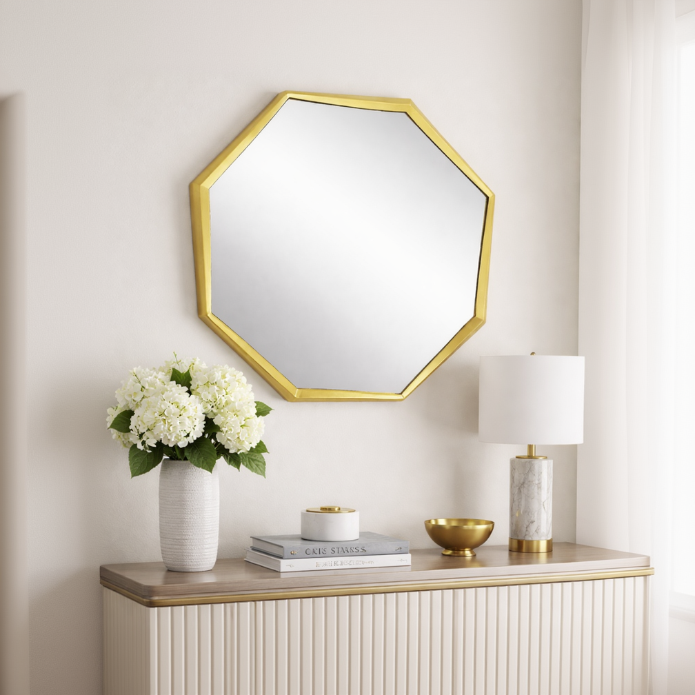 Brich & Bronze Octavia faceted wall mirror with geometric faceted glass frame hanging on a wall.