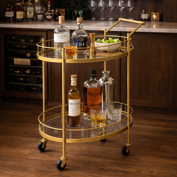 Brich & Bronze Regent Oval Luxe Bar Cart with gold-toned metal frame and glass shelves, stylish and functional for home bar use.